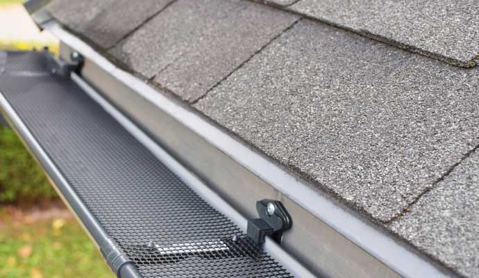 A clean and well-maintained gutter system attached to the edge of a roof.