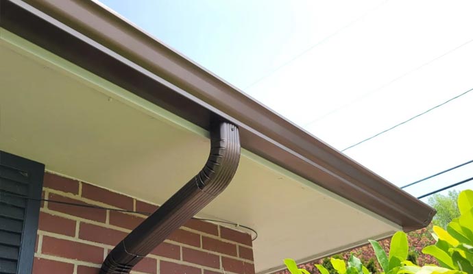 A well-maintained and clean gutter system attached to the edge of a house's roof