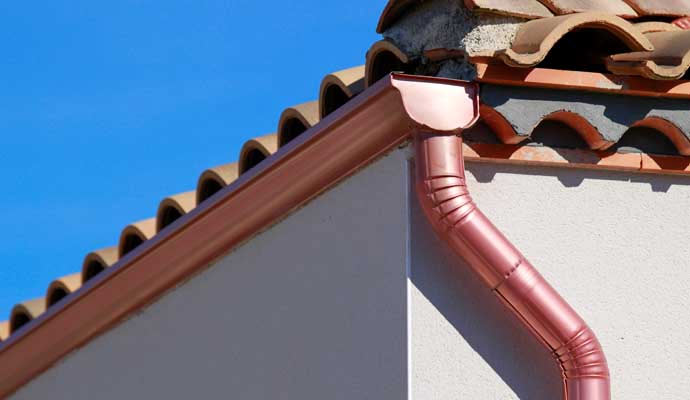 A copper gutter system installed on a building.