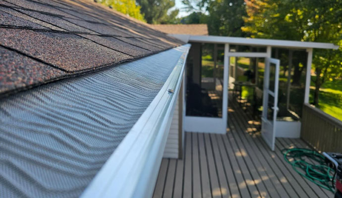 A gutter guard installed on a roof