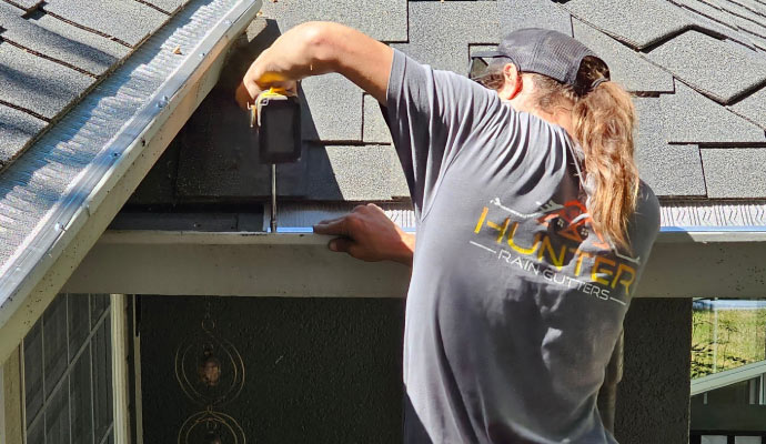 technician installing gutters