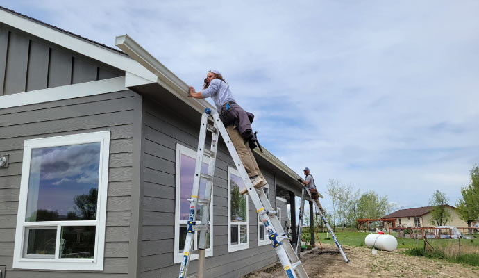 Technician installing rain gutters