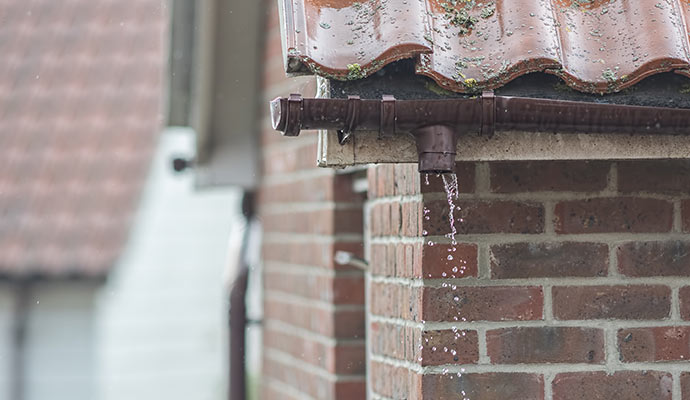 water leaking from damaged gutter