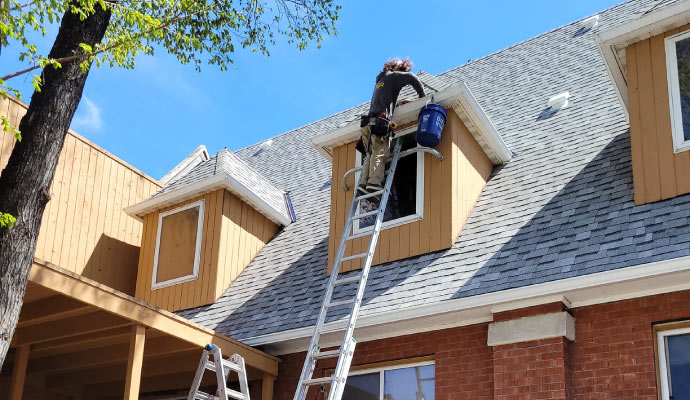 A person inspecting a gutter using equipmen