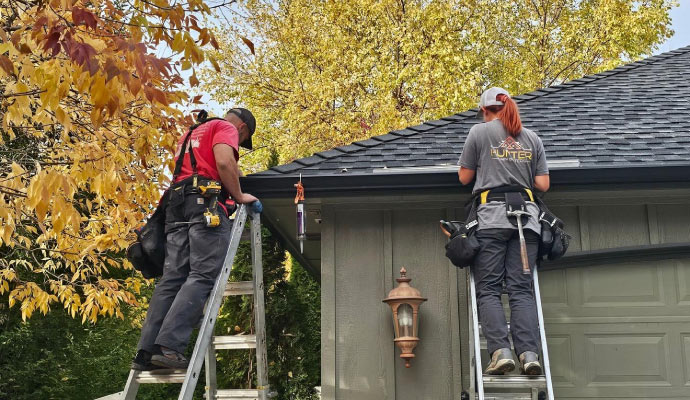 technician installing gutters