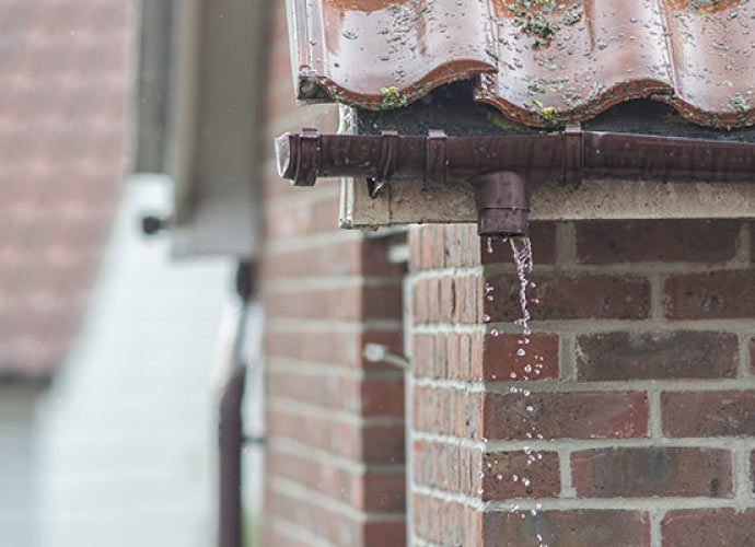 Close-up view of a leaking gutter