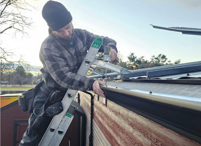 Professional installing a gutter