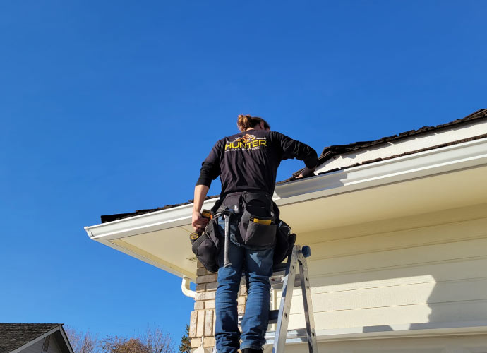 Professional repairing a gutter