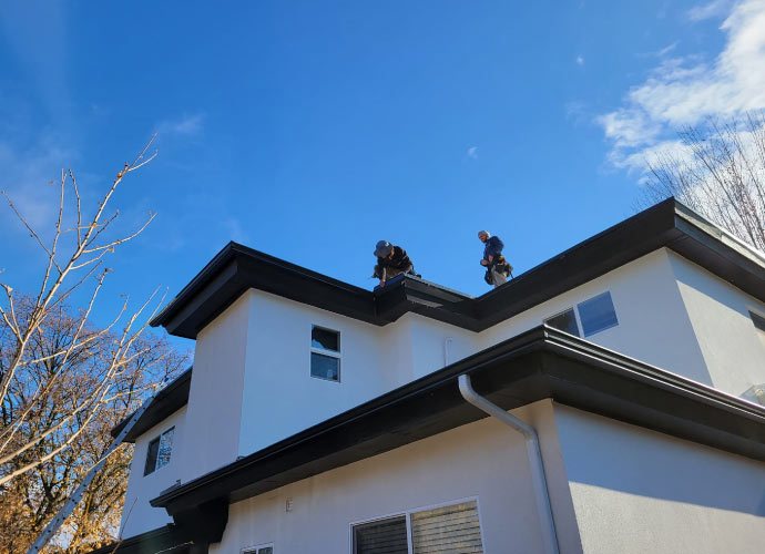 Professional team installing new gutter guard