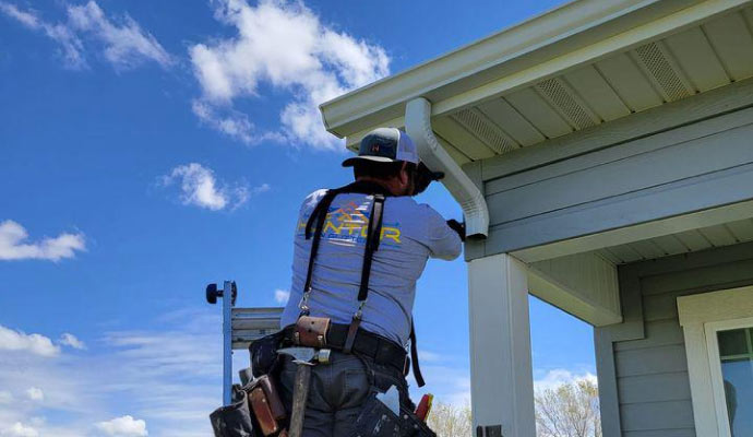 technician repairing rain gutters