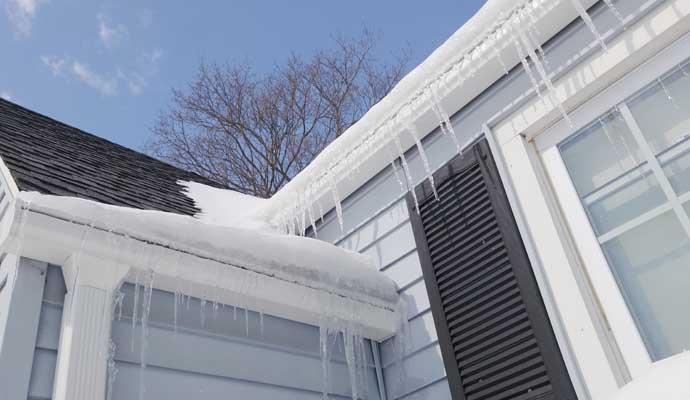 a house with gutter guards that are clogged with snow