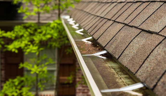 Prolonged water exposure damaged the gutter material leading to rust.