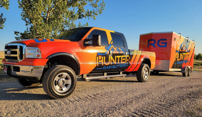 Hunter Rain Gutters vehicles standing on the road