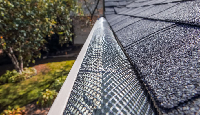 A close-up view of a gutter with reverse curve guard.